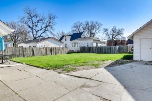 a yard with a fence and some houses at Charming Winterset Vacation Rental with Yard and Patio in Winterset
