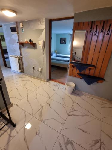 a living room with a marble floor and a bathroom at Holiday Home Baotic in Velika Mlaka