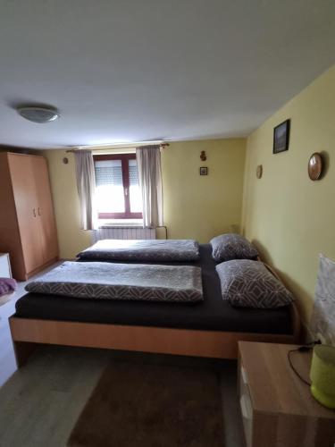 a bedroom with two beds and a window at Holiday Home in Velika Mlaka