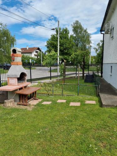 a park with a bench and a brick oven at Holiday Home in Velika Mlaka