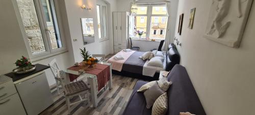 a small room with a bed and a couch at Old Square view apartment in Split
