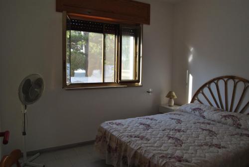a bedroom with a bed and a window at Casa del Sole pt by Salento Prime in Marina di Pescoluse
