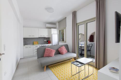 a living room with a couch and a table at Porto Bello di Paros in Parikia