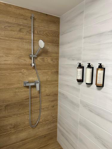 a bathroom with a shower with two bottles of soap at Piękna Góra in Giżycko
