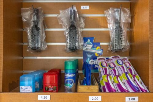 a shelf with toothbrushes and other items on it at Hôtel Saint-Laurent Montréal in Montréal