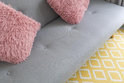 a close up of two pink stuffed animals on a bed at Porto Bello di Paros in Parikia