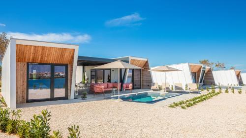 a rendering of a house with a pool and umbrellas at Aminess Avalona Glamping Villas & Mobile Homes in Povljana