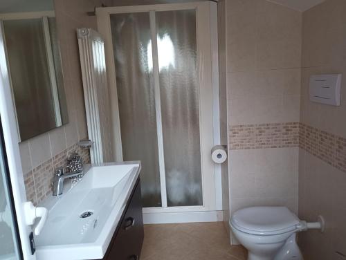 a bathroom with a toilet and a sink and a shower at Divingreta 1820 in Ottaviano