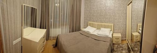 a bedroom with a bed and a desk and a mirror at 2 комнатная квартира в центре Еревана in Yerevan