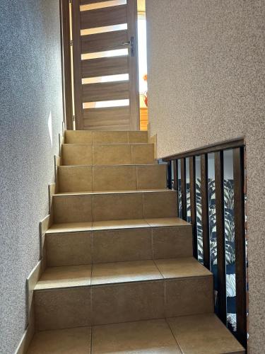 a set of stairs with a door in a building at Piękna Góra in Giżycko
