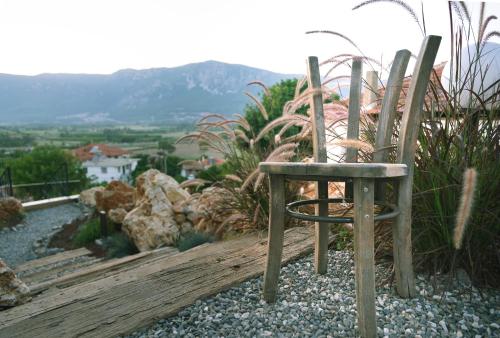 a wooden chair sitting on top of a hill at Kikonia Art & Suites in Akyaka