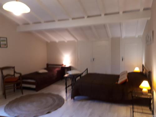 a living room with two beds and a couch at Maison GAINEKO ETXEA in Ostabat-Asme