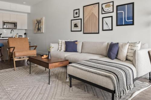 a living room with a couch and a table at City Views - Lifestyle Loft - Zuni Lofts in Denver