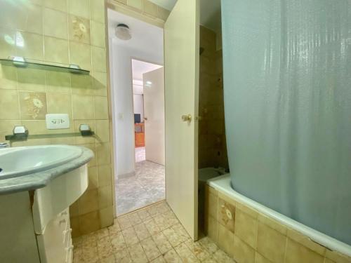 a bathroom with a shower and a sink and a tub at Plaza Mediterránea in Gandía