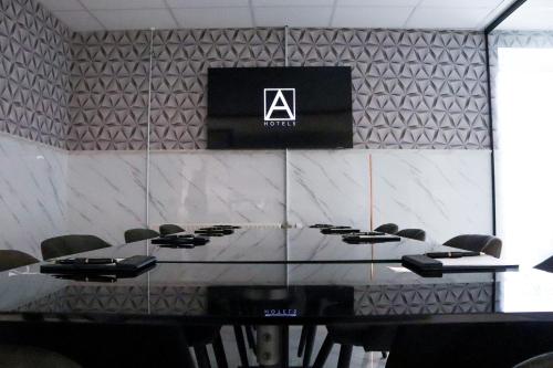 a conference room with a table and a sign on a wall at A Hotels Glostrup in Glostrup