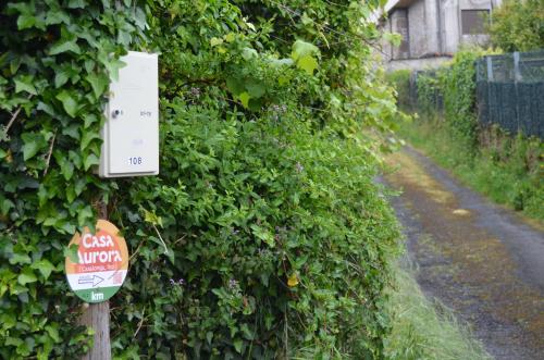 a sign on the side of a bush at Casa Aurora in Teo