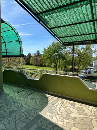 a green roof with a glass structure on a patio at Villa Oaza in Bela Crkva