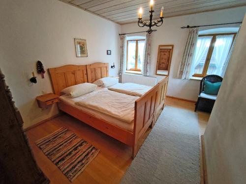 a bedroom with a bed and a chandelier at Bauernhof Geigerhof in Aschau im Chiemgau