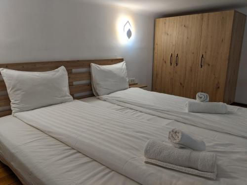 sypialnia z dużym łóżkiem z białą pościelą i poduszkami w obiekcie Ultra-central apartment in the Dauerbach Palace w mieście Timişoara