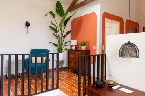 a room with a table and chairs and a plant at Quinta dos Pernobes in Arelho