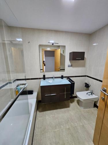 a bathroom with a sink and a toilet at Apartamento Luz in Sueca