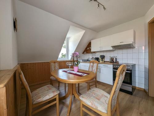 a small kitchen with a wooden table and chairs at Ferienwohnungen Langer in Stadt Wehlen