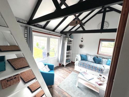 a living room with a couch and a table at Saving Grace with private hot tub in Bawdeswell