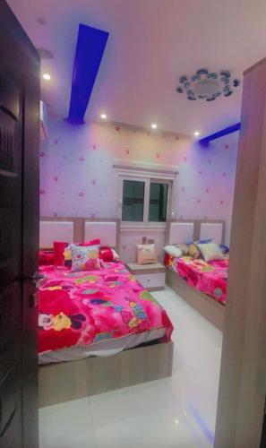 ein Schlafzimmer mit 2 Betten und einer mit Konfetti bedeckten Wand in der Unterkunft Hotel apartment in Kairo