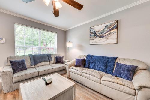 a living room with two couches and a table at Baton Rouge Home with Yard about 14 Mi to Downtown! in Baton Rouge