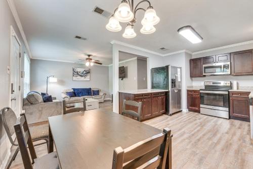 a kitchen and living room with a table and a couch at Baton Rouge Home with Yard about 14 Mi to Downtown! in Baton Rouge