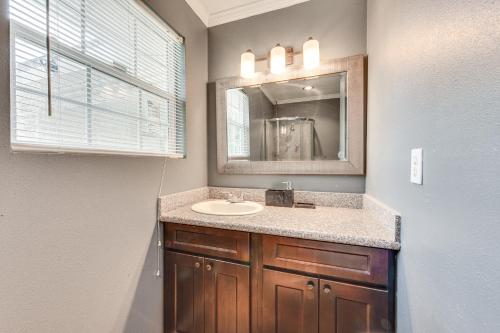 a bathroom with a sink and a mirror at Baton Rouge Home with Yard about 14 Mi to Downtown! in Baton Rouge