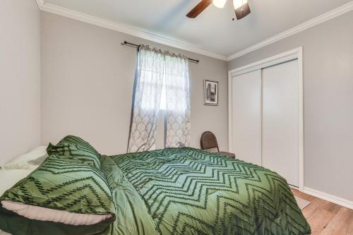 a bedroom with a bed and a window at Baton Rouge Home with Yard about 14 Mi to Downtown! in Baton Rouge