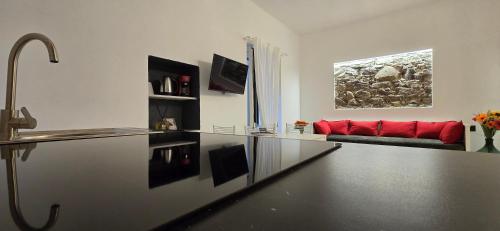 a living room with a red couch in a room at The white cave- Bluchalet in Riomaggiore