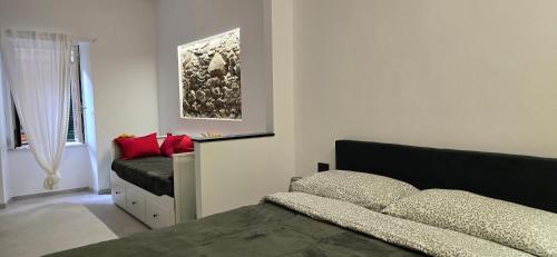 a bedroom with two beds with red pillows at The white cave- Bluchalet in Riomaggiore