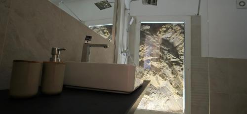 a bathroom with a sink and a view of a mountain at The white cave- Bluchalet in Riomaggiore