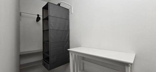 a bathroom with a white counter and a black shelf at The white cave- Bluchalet in Riomaggiore