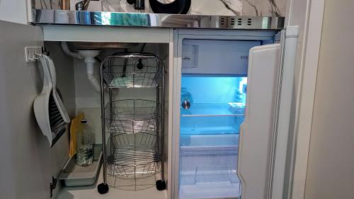 an empty refrigerator with its door open in a kitchen at El laurel y el limonero. in Las Pajanosas