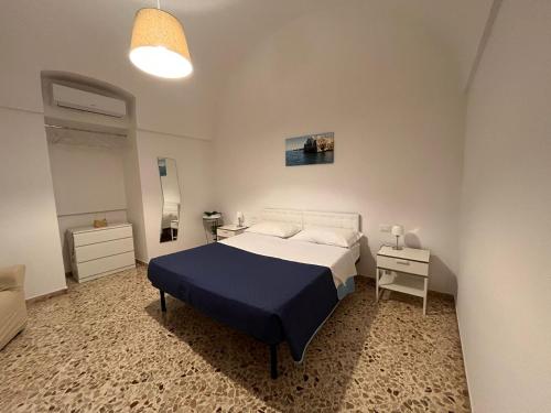 a small bedroom with a bed and a night stand at A casa di nonna Lina in Polignano a Mare