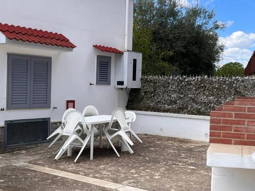 a table and chairs sitting outside of a white house at A casa di nonna Lina in Polignano a Mare