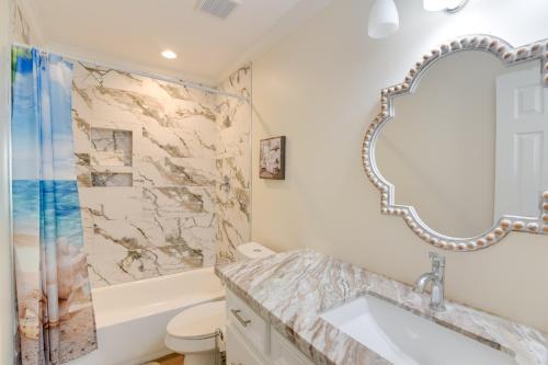 a bathroom with a sink and a mirror at Less Than 1 Mi to Historic Pleasure Pier Galveston Home! in Galveston