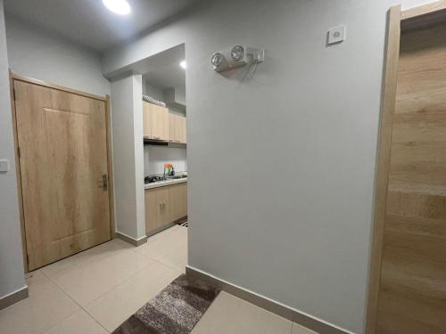 a room with a hallway with a door and a kitchen at Cozy One-Room Apartment Stay in Hulhumale