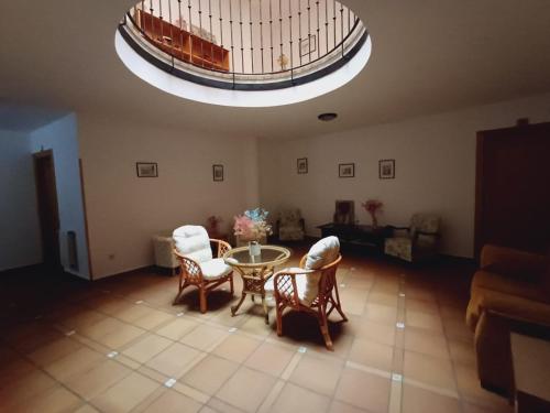 a living room with a table and chairs at Hotel Apartamentos El Coterin in Arenas de Cabrales