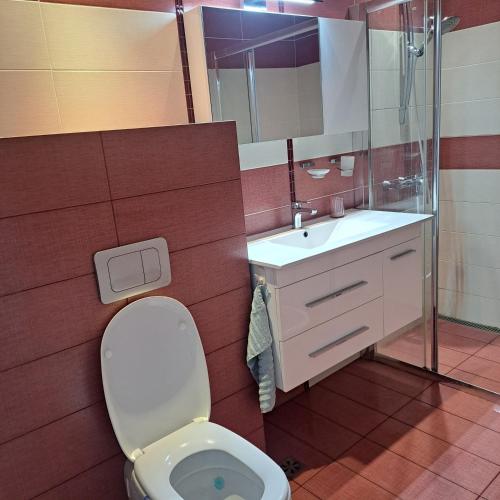 a bathroom with a toilet and a sink at Perla 1 apartments in Ravda