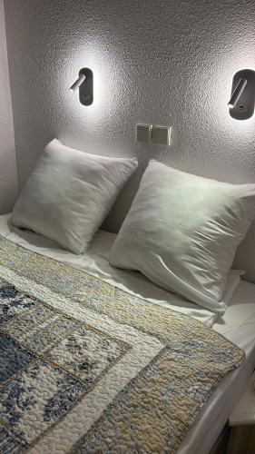 un lit avec deux oreillers dessus dans l'établissement Résidence La Palme d'Azur - Petersen App 610, à Cannes