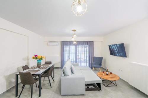 a living room with a white couch and a table at IAIRA in Athens