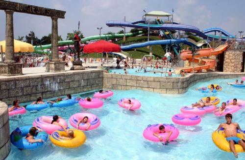 a group of people in a pool at a water park at Beach perfect getaway 2 bedroom apartment in Rehoboth Beach