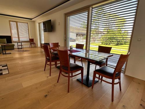 a dining room with a glass table and chairs at Paradies in Bad Radkersburg