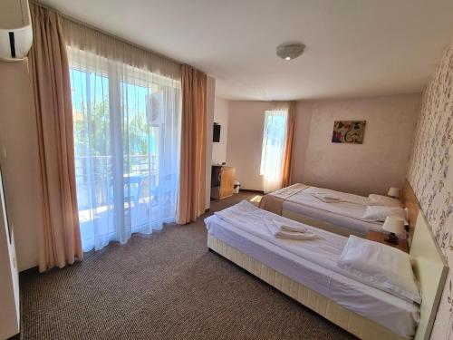 Postel nebo postele na pokoji v ubytování Hotel Mida