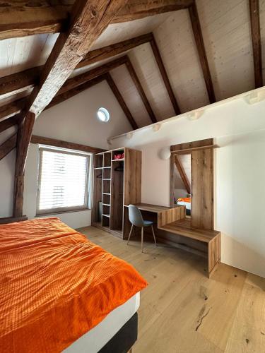 an attic bedroom with a bed and a desk at Paradies in Bad Radkersburg