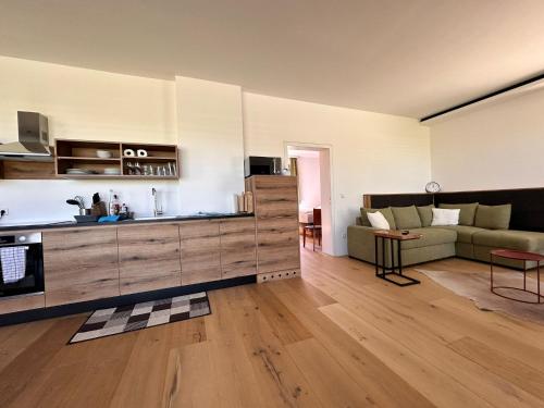 a large living room with a couch and a kitchen at Paradies in Bad Radkersburg